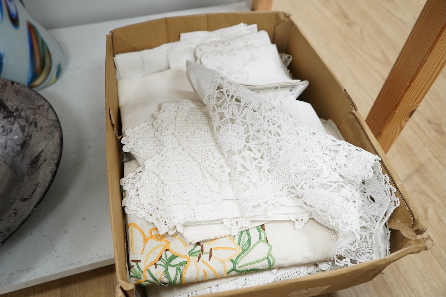 A collection of embroidered and crochet linen table cloths etc